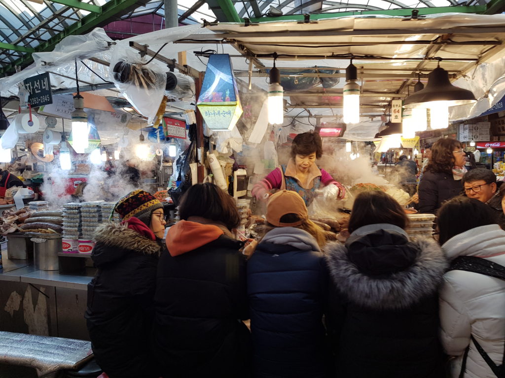 People eating at Gwangjang market in Seoul, South Korea