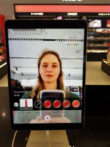 Woman using a tablet in a cosmetic store in Seoul, South Korea
