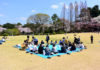 Office workers having a Sakura picnic Sinjuku Gyoen garden in Tokyo, Japan