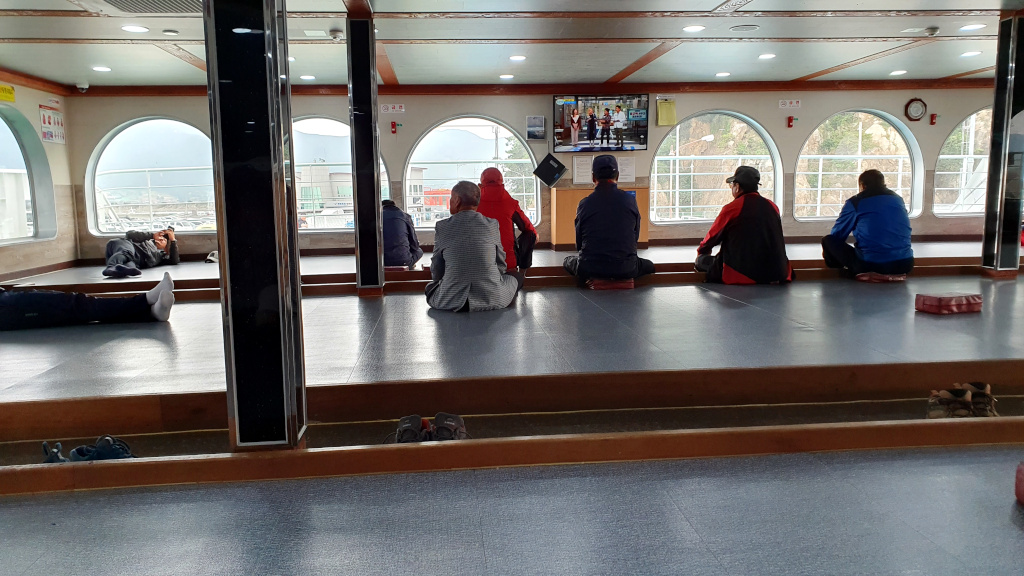 People relaxing on the ferry from Wando to Bogil Island in South Korea